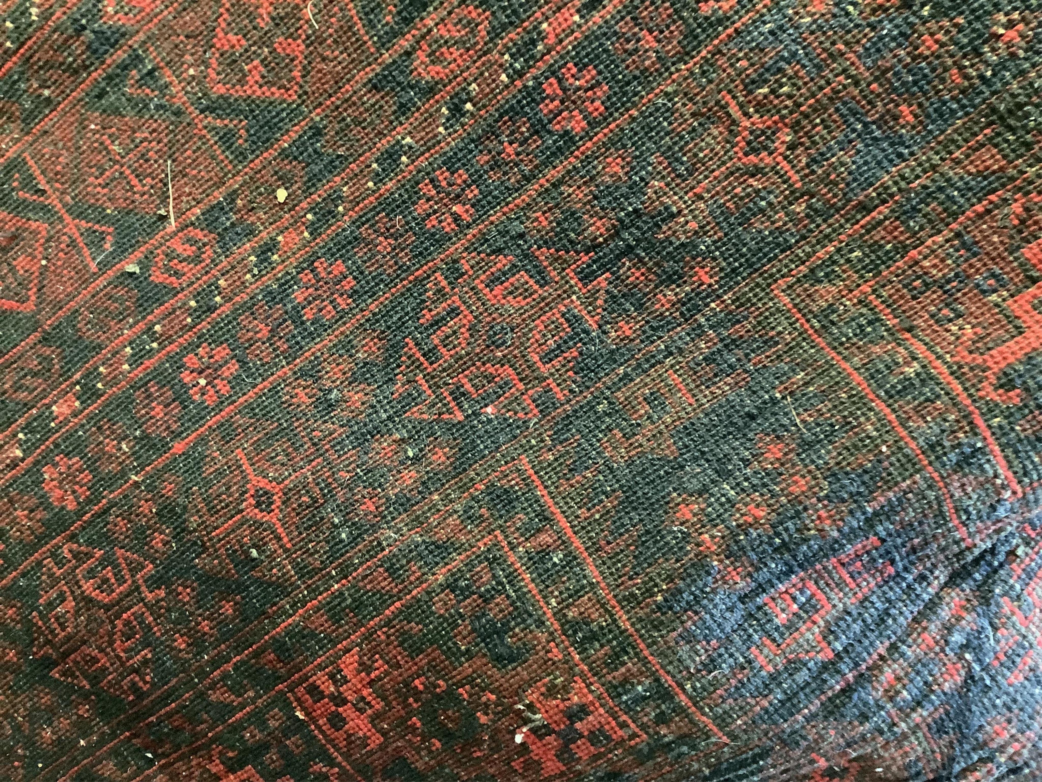A red ground Afghan rug, 250 x 148cm. Condition - good